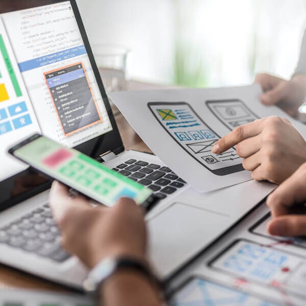UX designers at work testing designs on desktop and mobile.